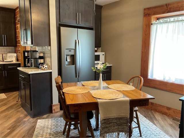 dining space with light wood-type flooring