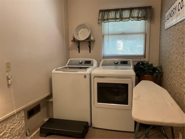 clothes washing area with washer and clothes dryer