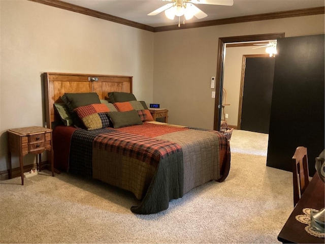 carpeted bedroom featuring ceiling fan and crown molding