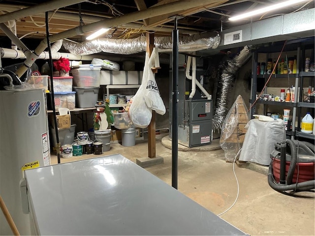 basement featuring water heater and heating utilities