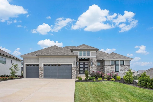 prairie-style house featuring a front yard and a garage