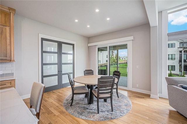 dining room featuring light hardwood / wood-style floors and french doors