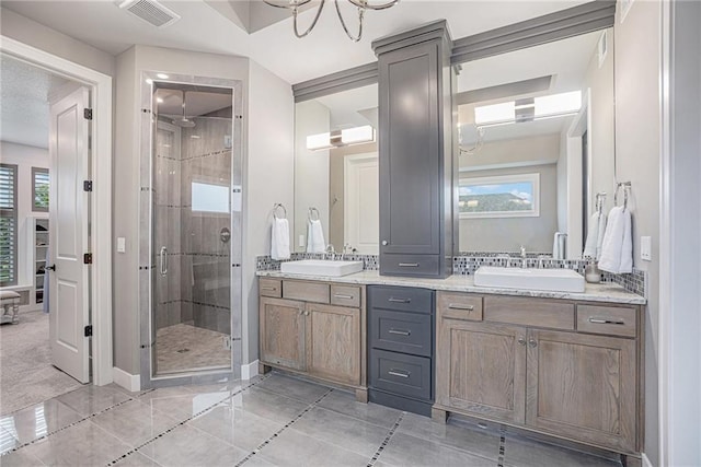 bathroom featuring an enclosed shower, vanity, and tile patterned floors