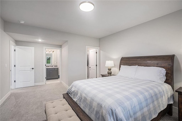 carpeted bedroom featuring connected bathroom