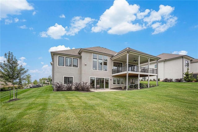 rear view of house featuring a patio area, ceiling fan, and a lawn