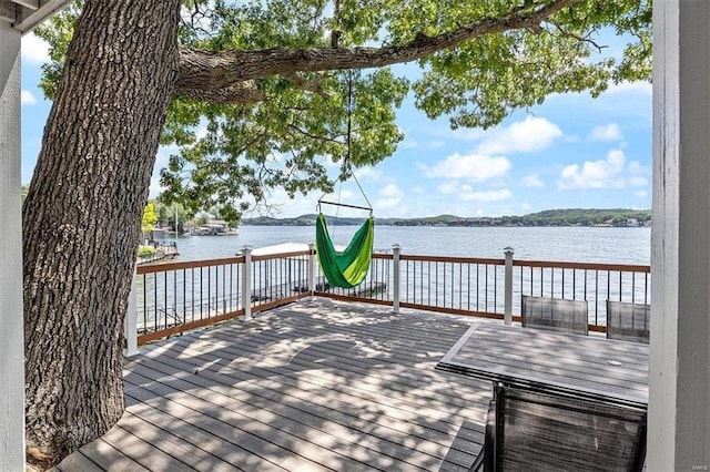 dock area featuring a deck with water view