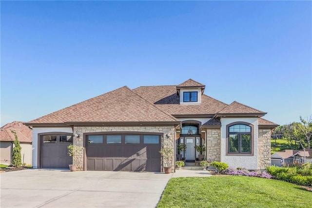 view of front of property featuring a garage and a front yard