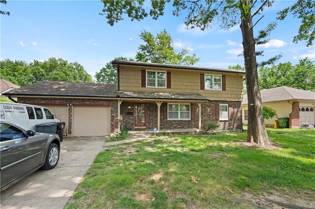 view of property featuring a front yard and a garage