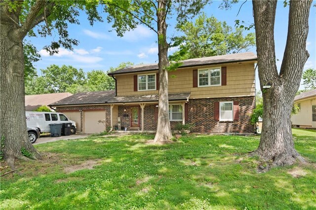 view of front of property with a front yard and a garage