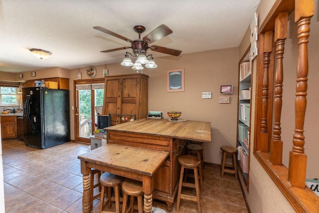 dining room with ceiling fan and light tile patterned floors