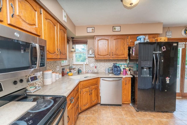 kitchen featuring decorative backsplash, stainless steel appliances, sink, and light tile patterned floors