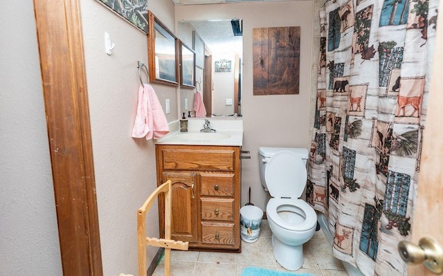 bathroom featuring vanity, toilet, and tile patterned flooring