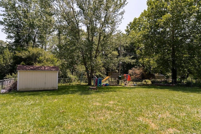 view of yard with a playground and a storage shed