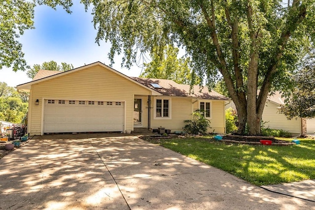 ranch-style house with a garage and a front lawn