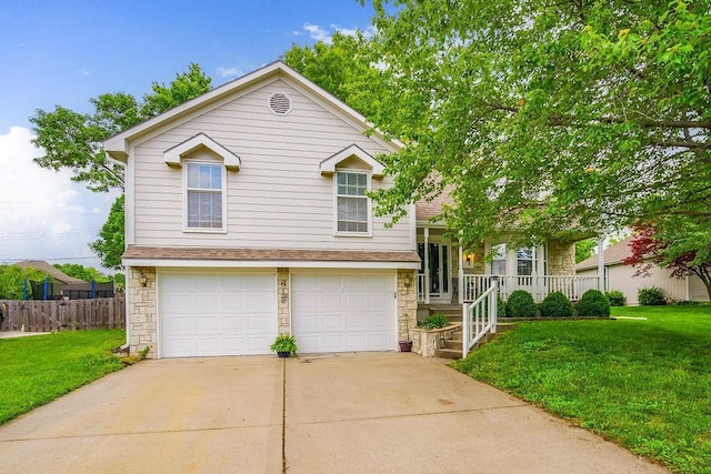 tri-level home with a garage, a front lawn, and a porch