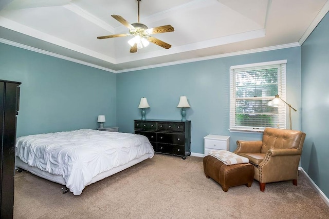 bedroom featuring a tray ceiling, ornamental molding, ceiling fan, and carpet flooring