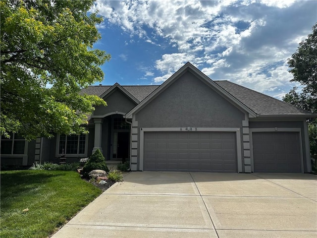 ranch-style house featuring an attached garage, a shingled roof, driveway, stucco siding, and a front lawn