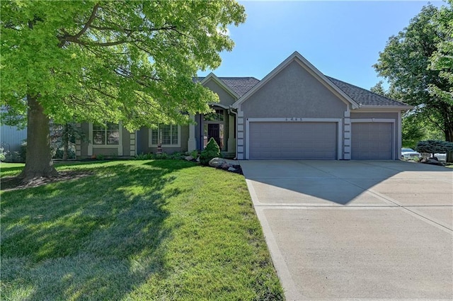 view of front of property with a front yard and a garage