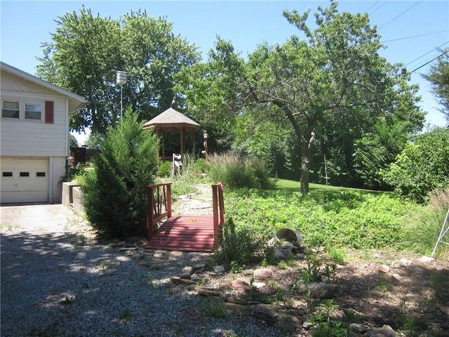 view of yard with a garage and a deck