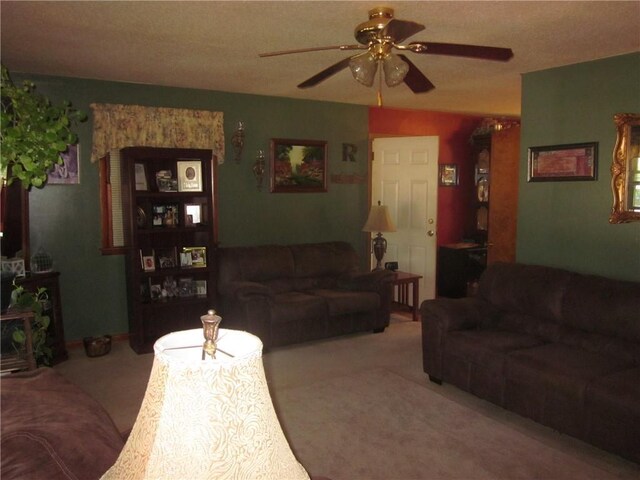 carpeted living room with ceiling fan