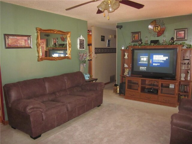 carpeted living room with ceiling fan