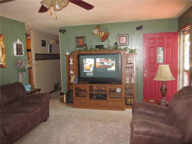 carpeted living room featuring ceiling fan