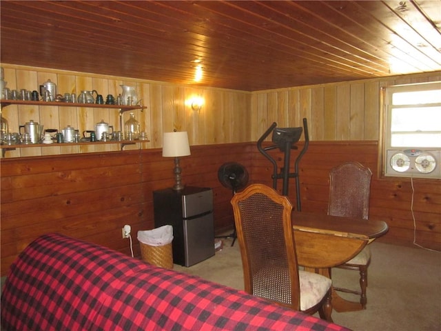 bedroom featuring light colored carpet, wood walls, and wood ceiling