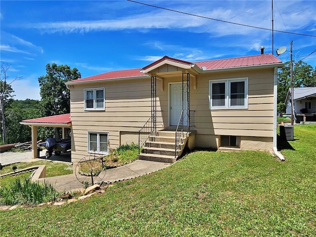 view of front of home featuring a front lawn and central air condition unit