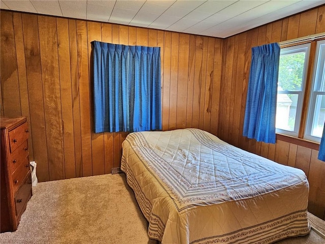 carpeted bedroom with wood walls