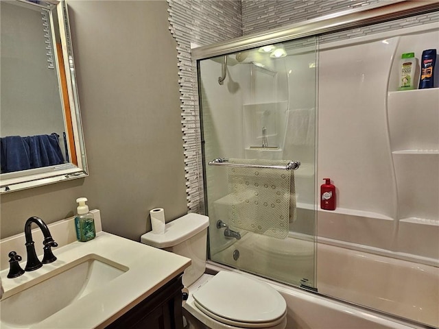 full bathroom with vanity with extensive cabinet space, enclosed tub / shower combo, and toilet