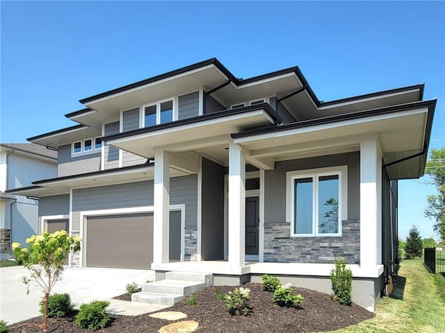 prairie-style house with a garage and a porch