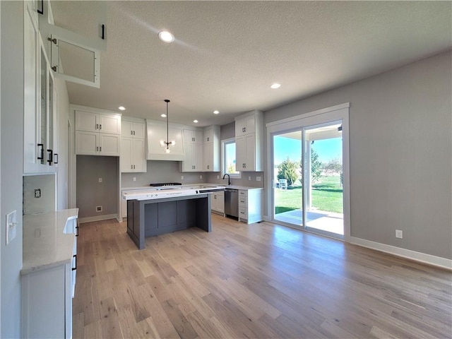 kitchen featuring light wood-type flooring, dishwasher, baseboards, recessed lighting, and white cabinetry