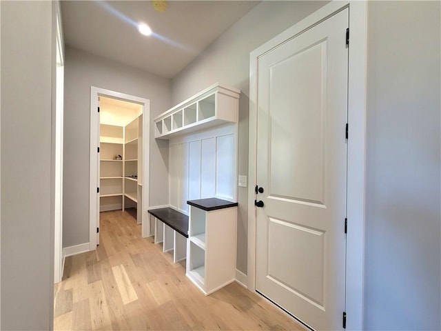 mudroom with baseboards and light wood finished floors