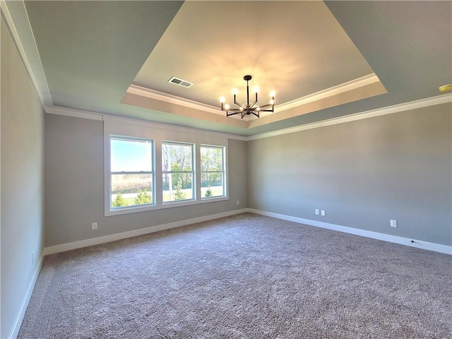 empty room featuring visible vents, crown molding, an inviting chandelier, a tray ceiling, and carpet