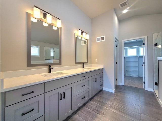 bathroom featuring vanity, lofted ceiling, and tile patterned floors