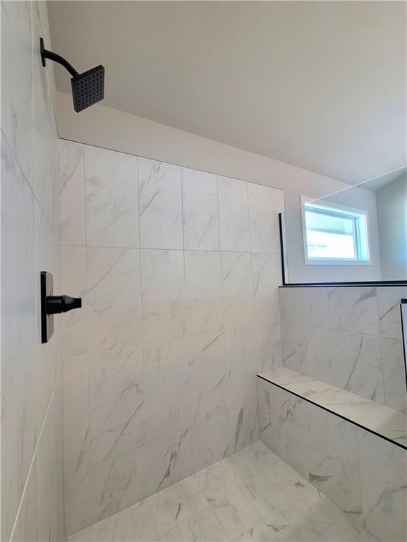 full bathroom featuring tiled shower