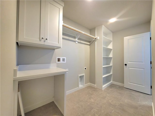 washroom featuring cabinet space, baseboards, washer hookup, and electric dryer hookup