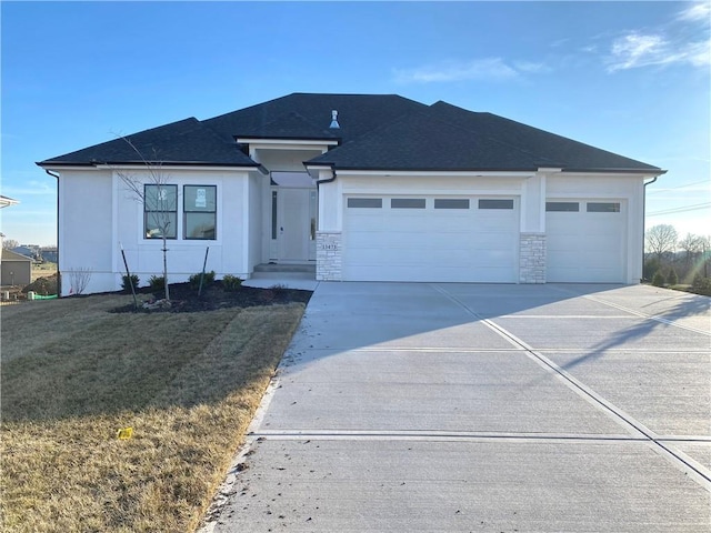 view of front of house with a garage and a front lawn