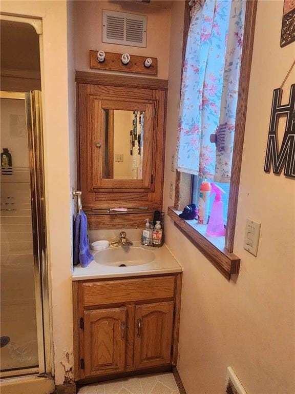 full bath with visible vents, a shower stall, and vanity