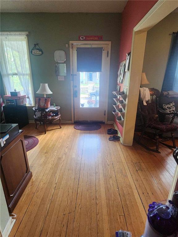 foyer featuring baseboards and light wood finished floors