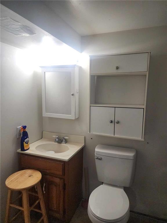 half bathroom with toilet and vanity