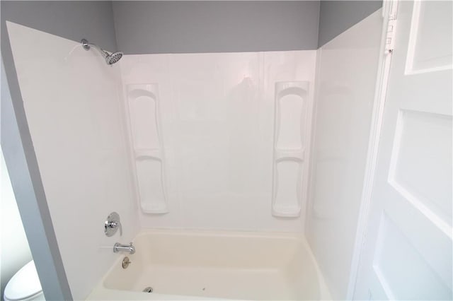 bathroom featuring toilet and shower / washtub combination