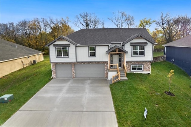 split foyer home with a garage and a front lawn