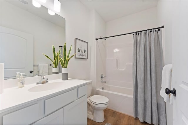 full bathroom with toilet, vanity, shower / bathtub combination with curtain, and hardwood / wood-style floors