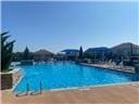 view of swimming pool with a view of the beach and a water view