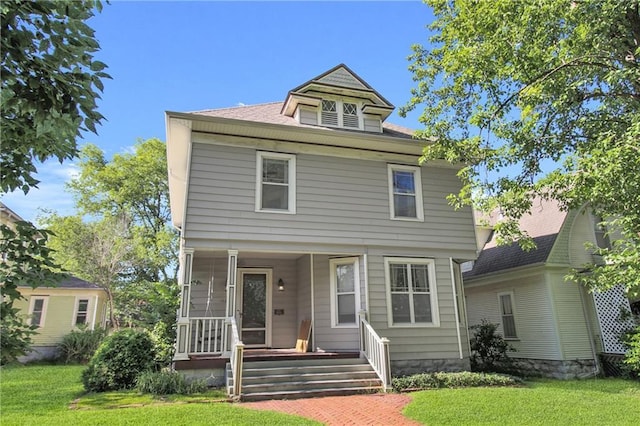 view of front of property featuring a sunroom and a front lawn