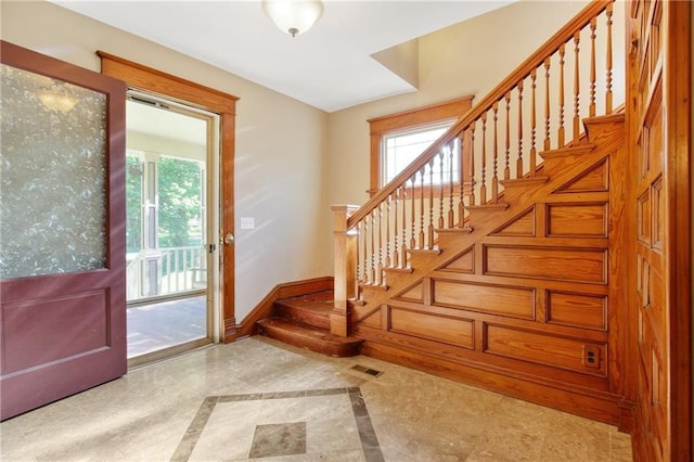 entryway featuring stairs, plenty of natural light, visible vents, and baseboards