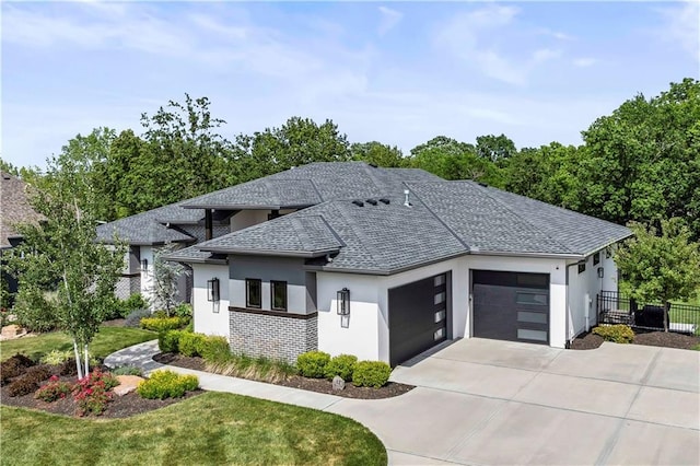 view of front of property featuring a front yard and a garage