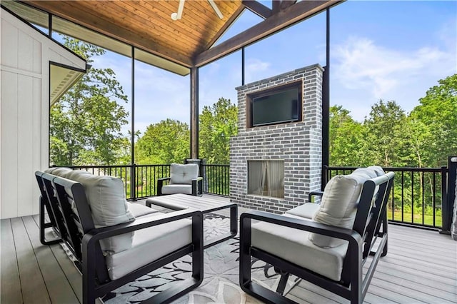 sunroom featuring wood ceiling, a wealth of natural light, and a fireplace