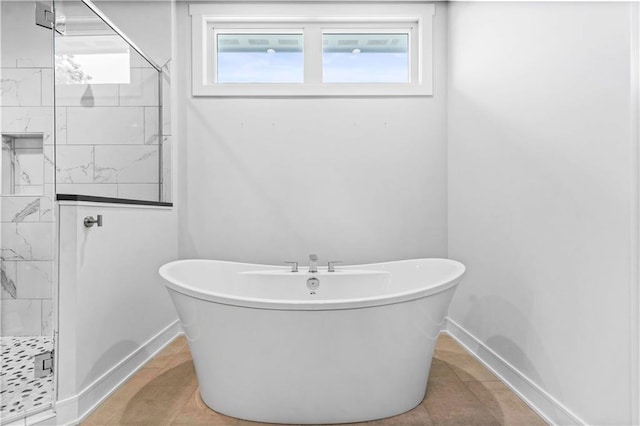 bathroom with separate shower and tub and tile patterned flooring